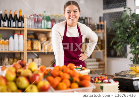 Smiling saleswoman behind the store counter 136763436