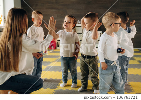 High five hands gesture. Children in kindergarten with their teacher High five hands gesture. Children in kindergarten with their teacher 136763721