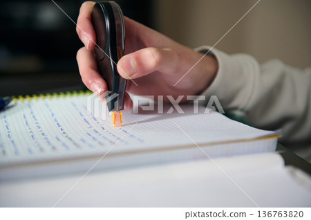 Teenage Student Doing Homework At Home Studying With Notebook And Correction Tape In Cozy Evening Light Teenage Student Doing Homework At Home Studying With Notebook And Correction Tape In Cozy Evening Light 136763820