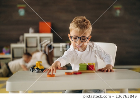 Motor skills, playing a game. Group of children are in the kindergarten 136763849