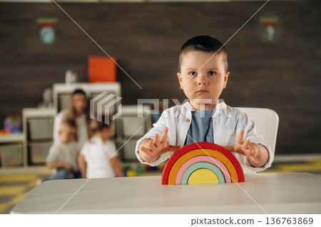 Rainbow toy game. Group of children are in the kindergarten Rainbow toy game. Group of children are in the kindergarten 136763869