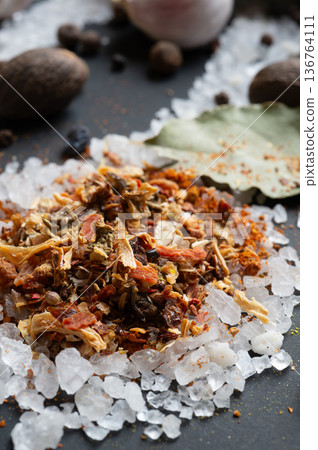 seasonings background with salt, Spices served at black. natural meal additives. healthy food concept. extreme macro shot seasonings background with salt, Spices served at black. natural meal additives. healthy food concept. extreme macro shot 136764111
