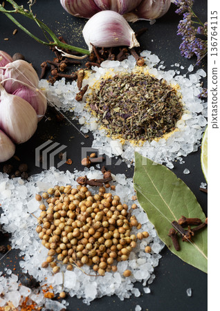 seasonings background with salt, Spices and garlic served at black. natural meal additives. healthy food concept. macro shot seasonings background with salt, Spices and garlic served at black. natural meal additives. healthy food concept. macro shot 136764115