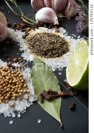 seasonings background with salt, Spices and garlic served at black. natural meal additives. healthy food concept. macro shot seasonings background with salt, Spices and garlic served at black. natural meal additives. healthy food concept. macro shot 136764116