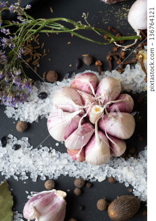 seasonings background with salt, Spices and garlic served at black. healthy food concept. top view macro shot seasonings background with salt, Spices and garlic served at black. healthy food concept. top view macro shot 136764121