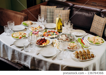 Festive banquet table with assorted dishes prepared for celebration dinner 136764366
