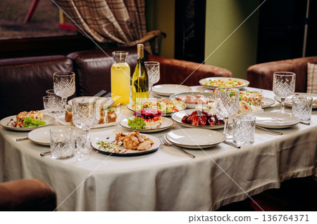 Festive banquet table with assorted dishes prepared for celebration dinner 136764371