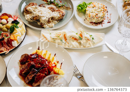 Elegant banquet table with gourmet meals, appetizers and festive restaurant serving Elegant banquet table with gourmet meals, appetizers and festive restaurant serving 136764373