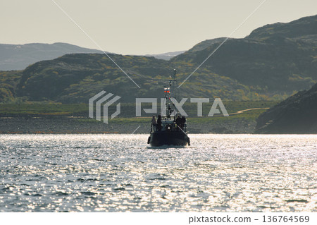 the coast of the Barents Sea, pleasure boats in the sea, the rocky shore with colourful arctic carpet of moss, yagel, Tundra at autumn the coast of the Barents Sea, pleasure boats in the sea, the rocky shore with colourful arctic carpet of moss, yagel, Tundra at autumn 136764569