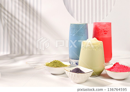 Assortment of colorful japanese tea latte with milk, green, blue, pink moon milk on sunny kitchen background. Trendy healthy drink promotes weight loss, has anti-inflammatory properties, 136764595