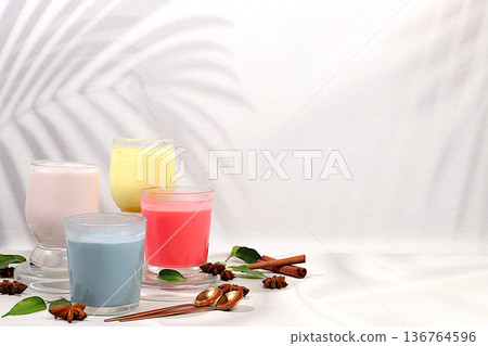 Assortment of different matcha chai lattes with milk on elegant kitchen sunny background and matcha powder. Traditional Indian drink rich in antioxidants, used for weight loss and treatment, . 136764596