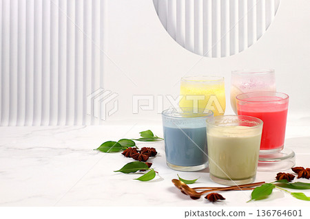 Assortment of different matcha chai lattes with milk on elegant kitchen sunny background and matcha powder. Traditional Indian drink rich in antioxidants, used for weight loss and treatment, . 136764601