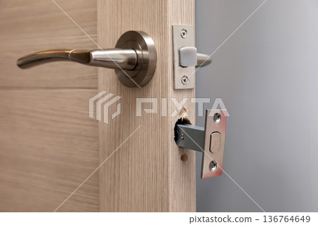 Installing a new door handle, closeup shot Installing a new door handle, closeup shot 136764649