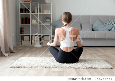 Young woman practicing yoga at home 136764655