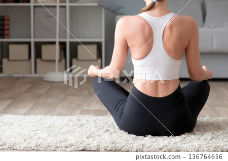 Young woman practicing yoga at home, closeup 136764656