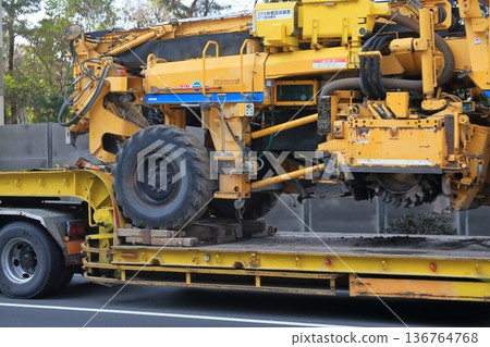 Trailer transporting heavy machinery Trailer transporting heavy machinery 136764768