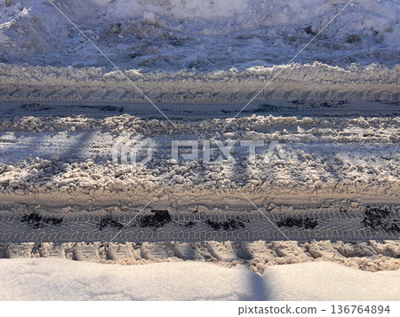 Winter road showing vehicle tire tracks in snow and slush Winter road showing vehicle tire tracks in snow and slush 136764894