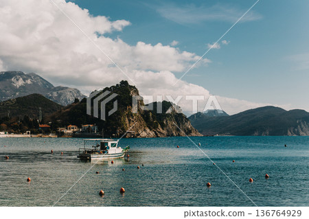 Amazing view of the Adriatic sea and a boat near Petrovac, Montenegro. Amazing view of the Adriatic sea and a boat near Petrovac, Montenegro. 136764929