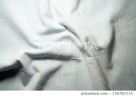 Denim texture of light blue fabric with folds 136765113