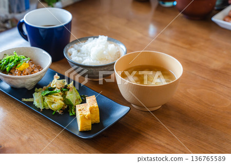Japanese breakfast: natto rice, miso soup, tamagoyaki (egg roll), vegetable side dish and coffee Japanese breakfast: natto rice, miso soup, tamagoyaki (egg roll), vegetable side dish and coffee 136765589