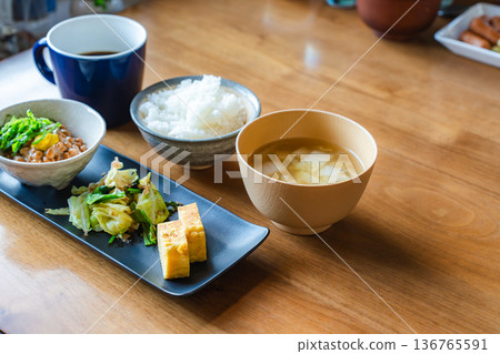 Japanese breakfast menu | Natto rice, miso soup, tamagoyaki (egg roll), vegetable side dish Japanese breakfast menu | Natto rice, miso soup, tamagoyaki (egg roll), vegetable side dish 136765591