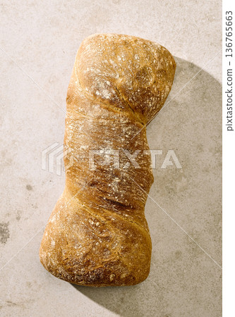 Rustic artisan bread loaf on light background, top view 136765663