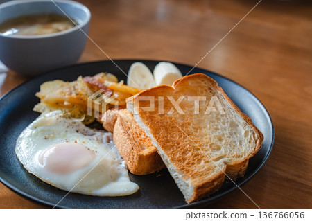 Aerial view of breakfast plate | Fried egg and toast on one plate Aerial view of breakfast plate | Fried egg and toast on one plate 136766056
