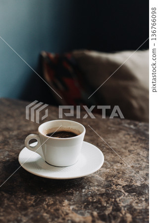 Cup of black coffee on a table in a cafe. Selective focus. 136766098