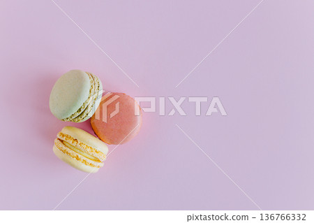 Tasty french macarons on a pink pastel background. 136766332