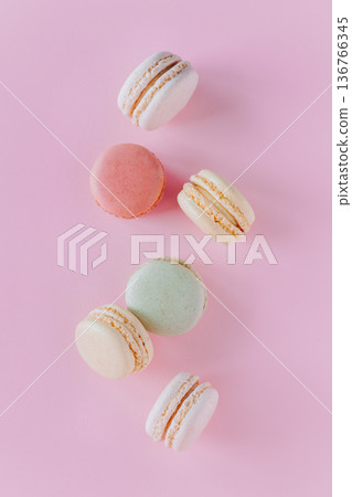 Tasty french macarons on a pink pastel background. Tasty french macarons on a pink pastel background. 136766345