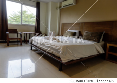 Blur background bedroom home interior in cozy decoration room. Clean soft bed stylish decor relax dorm with copy space. Modern apartment white light trendy style. Blurred background defocused indoors 136766420