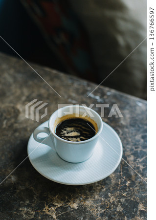 Cup of black coffee on a marble table in a cafe. 136766597