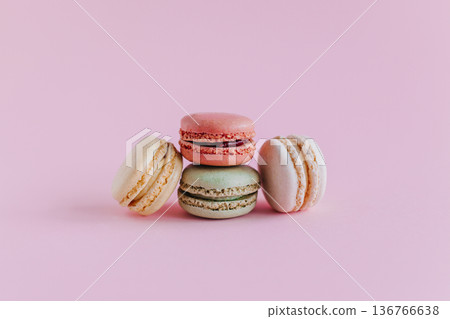 Tasty french macarons on a pink pastel background. 136766638