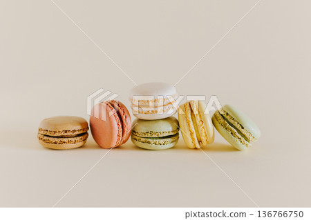 Tasty french macarons on a peach pastel background. 136766750