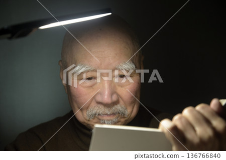 Old man reading a book Old man reading a book 136766840