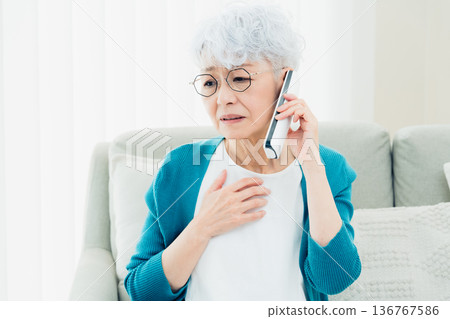 Senior woman talking on landline phone Senior woman talking on landline phone 136767586