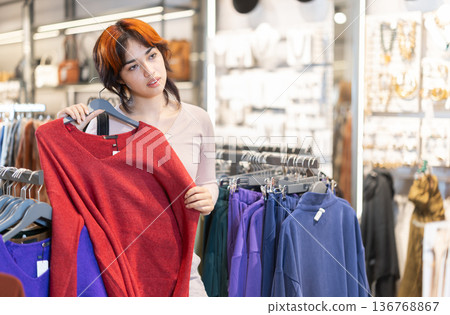 Young woman search and choose sweater Young woman search and choose sweater 136768867