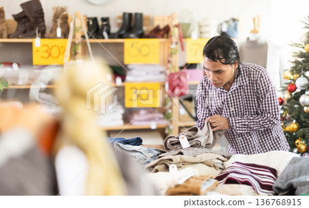 In chain shop, Indonesian man choose trousers, X mas shopping In chain shop, Indonesian man choose trousers, X mas shopping 136768915