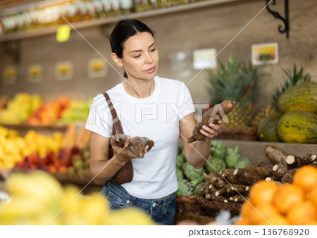 Woman choosing tapioca in a supermarket Woman choosing tapioca in a supermarket 136768920