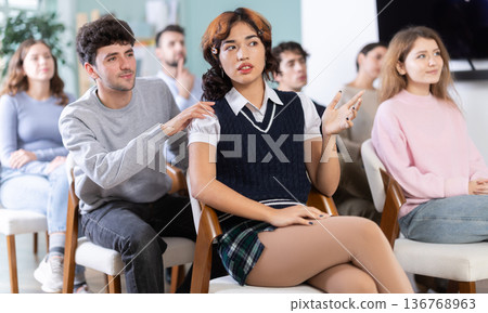 Guy student calls out to female classmate during class. Guy student calls out to female classmate during class. 136768963