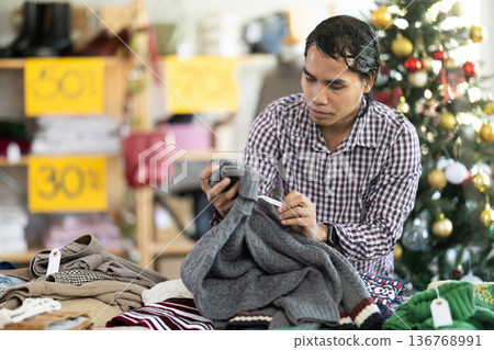 In chain shop, Indonesian man choose sweater, X mas shopping 136768991