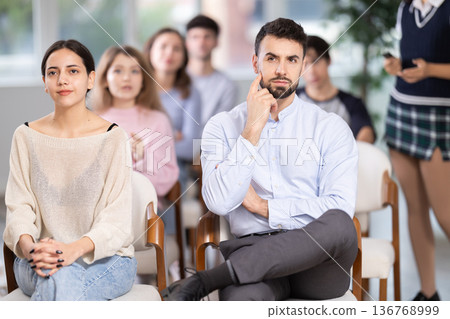 Group of young students listening during seminar in a modern classroom Group of young students listening during seminar in a modern classroom 136768999