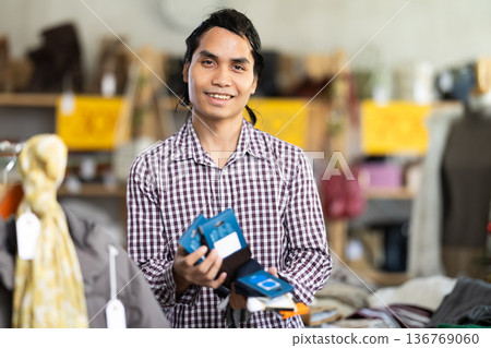 In chain shop, Indonesian man choose socks In chain shop, Indonesian man choose socks 136769060