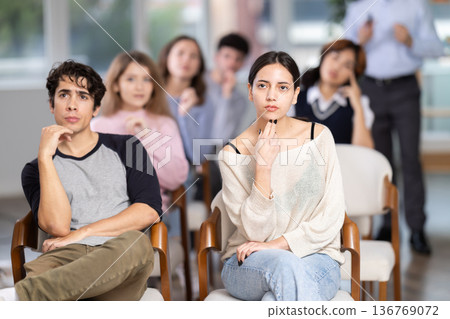 Group of young students listening during seminar in a modern classroom 136769072
