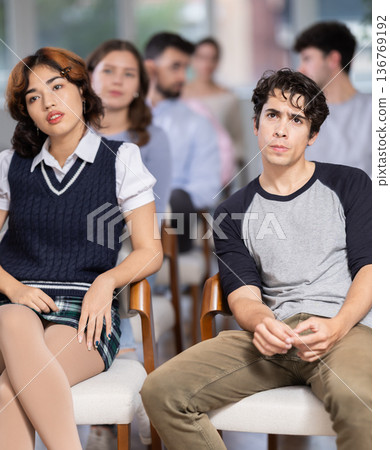 Young people are listening to lecture in auditorium Young people are listening to lecture in auditorium 136769192