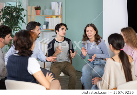 Guys and girls are sitting in circle and chatting. Guys and girls are sitting in circle and chatting. 136769236