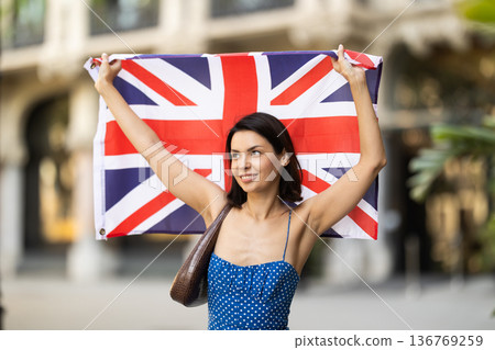 Young woman with UK flag on city street 136769259