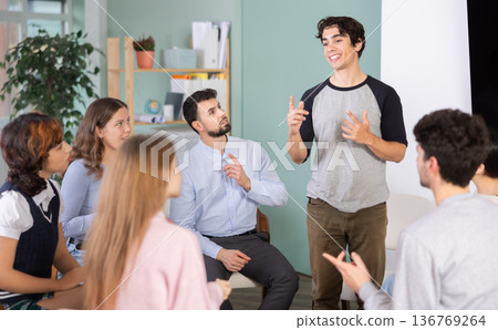 young man speaks to students in a classroom young man speaks to students in a classroom 136769264