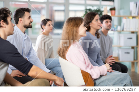 Group of young students listening during seminar in a modern classroom Group of young students listening during seminar in a modern classroom 136769287