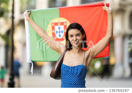 Young woman with portuguese flag on city street Young woman with portuguese flag on city street 136769297